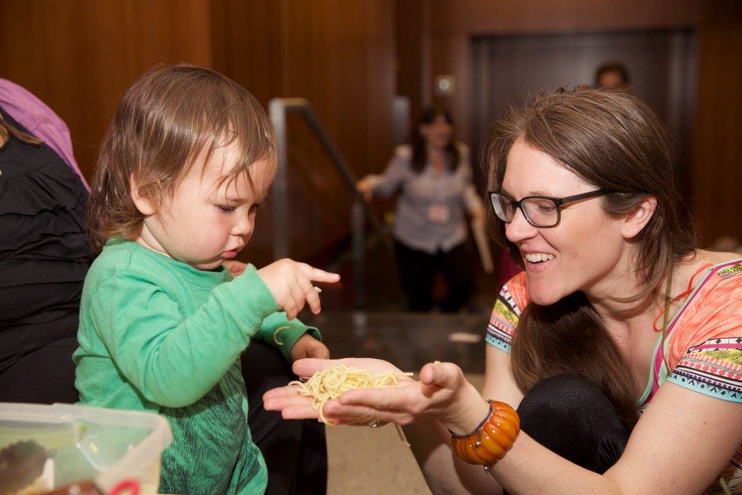 A caregiver and baby play during the Big Brooklyn Playdate. 