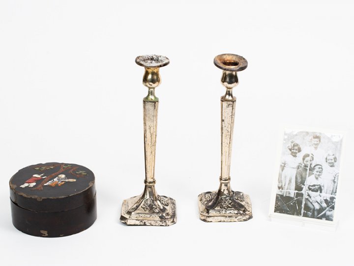 Notion storage box made in Shanghai, China with a pair of silver candlestick holders with Chinese inscriptions and a photo. Candlesticks courtesy of Menachem Shimonowitz, notion box and photo are courtesy of Chaya L. Small, shown here courtesy of Amud Aish Memorial Museum