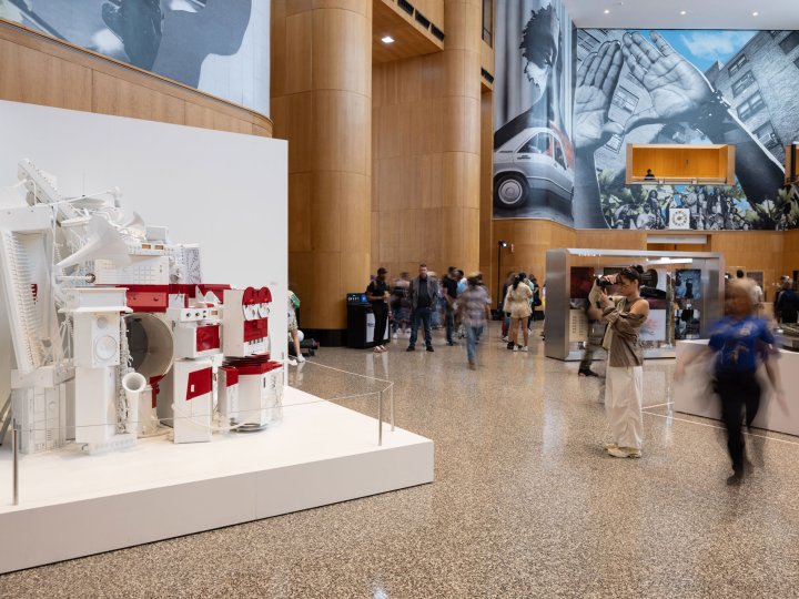 A white sculpture with three red lines from the Blueprint 3 album cover stands off to the side of the Grand Lobby at Brooklyn Public Library's Central branch as part of The Book of HOV exhibit