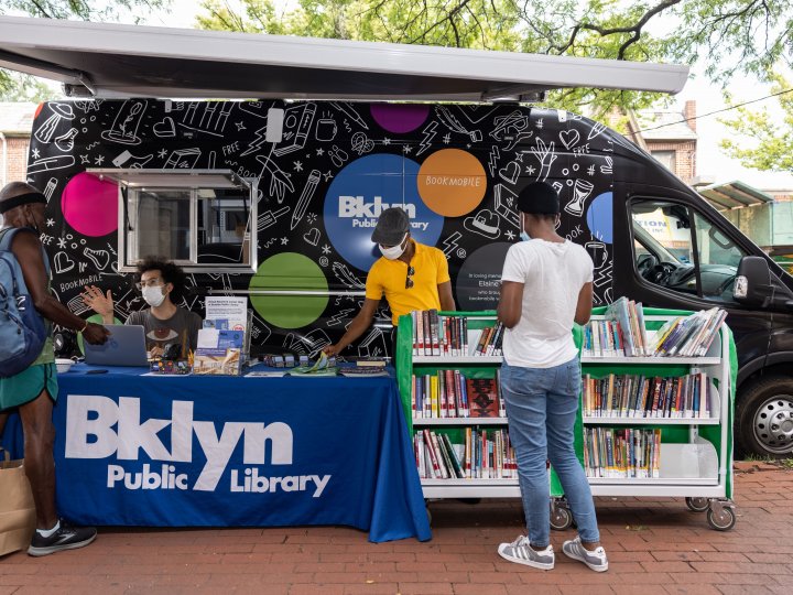People browsing at the Bookmobile's walk-up service