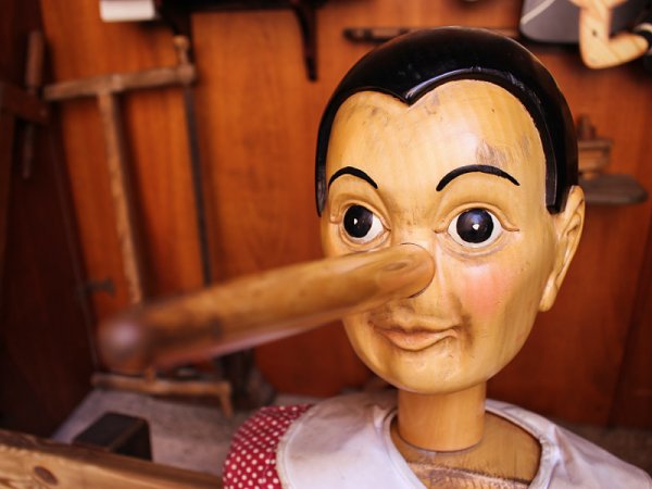 wooden Pinocchio puppet with long nose